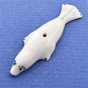 Inuit natural material whistle hole button of a realistic seal.