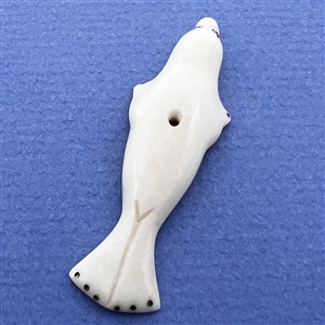 Inuit natural material whistle hole button of a realistic seal.