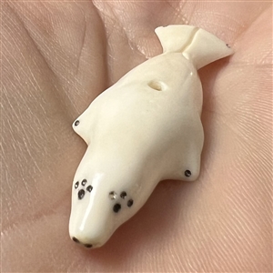 Inuit natural material whistle hole button of a realistic seal.