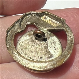 Art Deco snake button of silvered brass with glass.