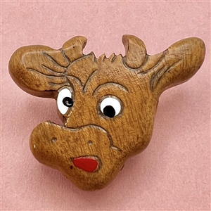 Vintage wood button of a realistic cartoon cows head.