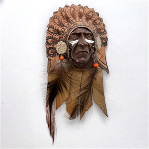 Mostly leather button of a Native American in a headdress with real feathers.