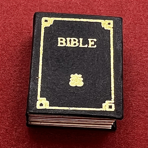 Leather and paper button of a realistic Bible that opens.