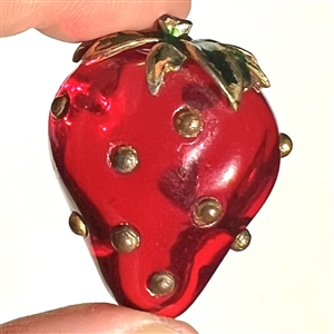 Realistic strawberry with metal stem.