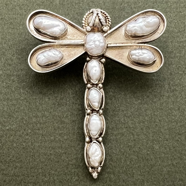 Silver button of a realistic dragonfly with seed pearls.