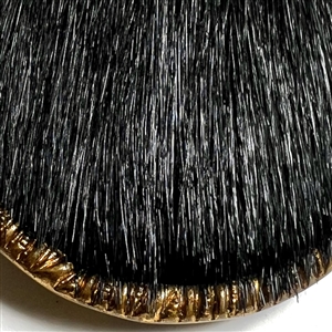 Animal fur with brass rim and tin back button.