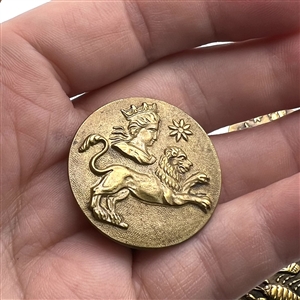 Set of five brass astrology buttons.