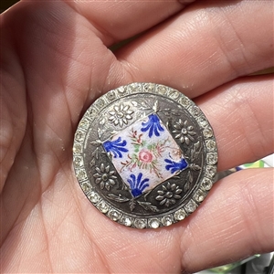 White metal button with flowers, enamel plaquette and paste border.