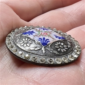 White metal button with flowers, enamel plaquette and paste border.