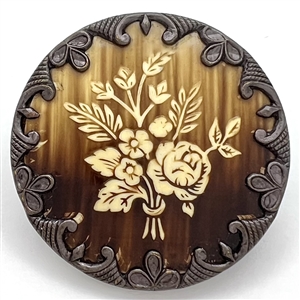 Victorian celluloid button set in metal with floral design.