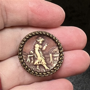“Victorian Girl Ivoroid button mounted in brass.