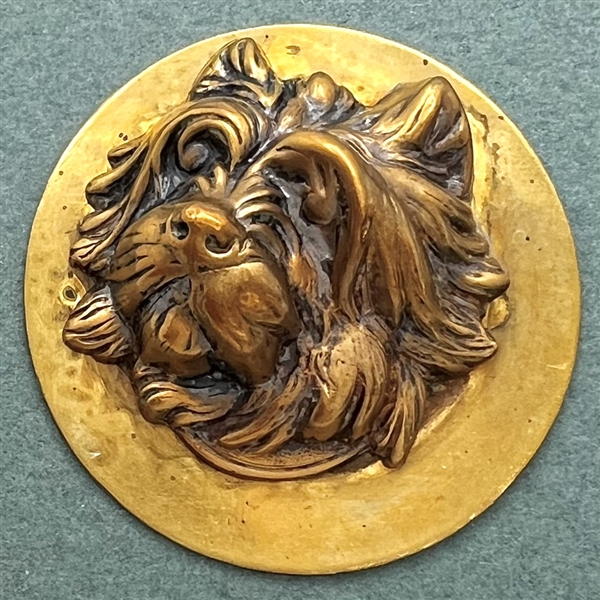 Brass button of a terrier.