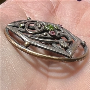 Jeweled button set in silvered brass, possibly from the suffragette movement.