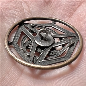 Jeweled button set in silvered brass, possibly from the suffragette movement.