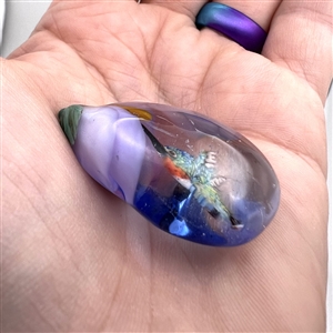 Mary Gaumond's hummingbird drinking from flower glass studio button.