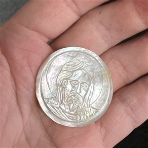 Bethlehem pearl button of Jesus with a halo.