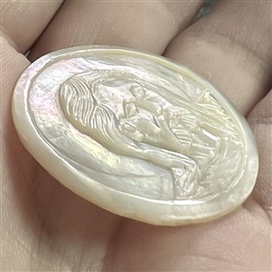 Bethlehem pearl button of Jesus with a halo.
