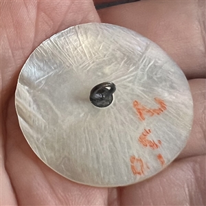 Bethlehem pearl button of Jesus with a halo.