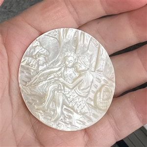 Bethlehem pearl button of man and woman in garden with sheep and a basket.