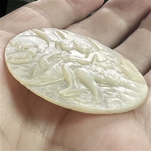 Bethlehem pearl button of man and woman in garden with sheep and a basket.