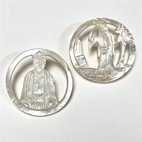 Two Bethlehem pearl buttons with open work of people.