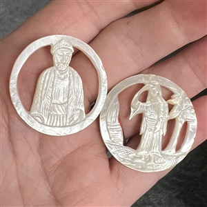 Two Bethlehem pearl buttons with open work of people.