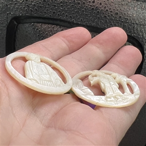 Two Bethlehem pearl buttons with open work of people.
