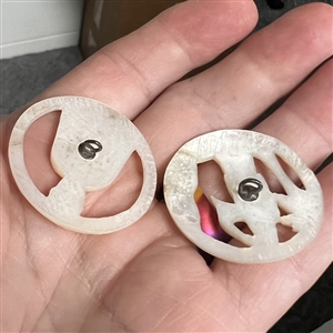 Two Bethlehem pearl buttons with open work of people.