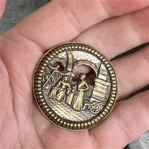 “Bazaar - button of two robed figures in an Eastern bazaar.