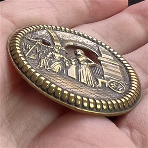 “Bazaar - button of two robed figures in an Eastern bazaar.