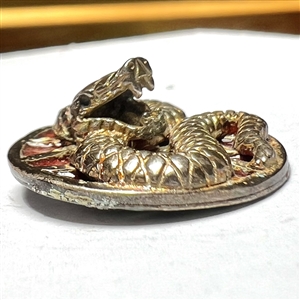 Sculptural gilded silver button of a snake with enamel background.