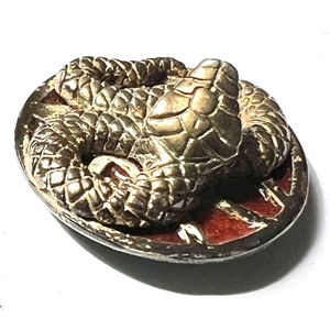 Sculptural gilded silver button of a snake with enamel background.