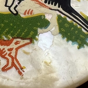 Painted pearl button two hunters on horseback with dog.