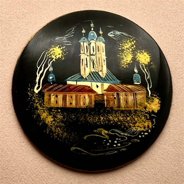 Russian lacquer button of a castle at night.