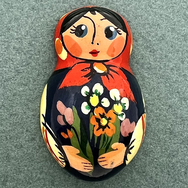 Russian lacquer button of a realistic Matryoshka doll.