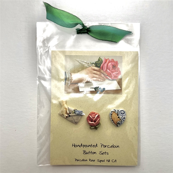 Original store card with three hand-painted porcelain buttons.