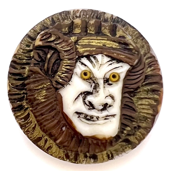 Carved natural material button of an Asian warrior.