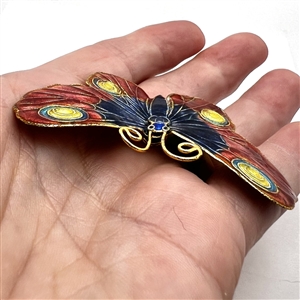 Cold enamel button of a realistic butterfly.