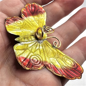 Cold enamel button of a realistic butterfly.