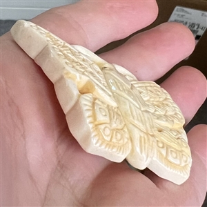 Carved natural material button of a realistic butterfly.
