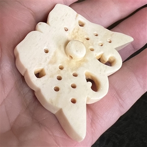 Carved natural material button of a realistic butterfly.