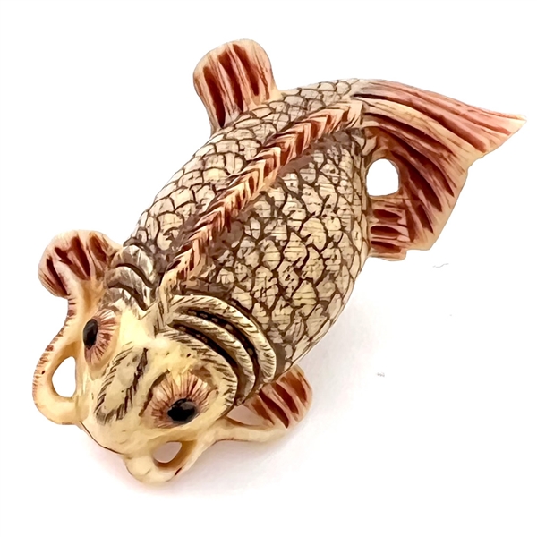 Carved natural material button of a realistic Koi fish.