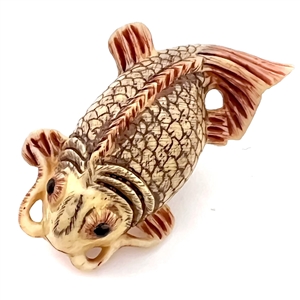 Carved natural material button of a realistic Koi fish.