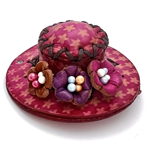 Leather button of a hat with flowers.