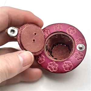 Leather button of a hat with flowers.