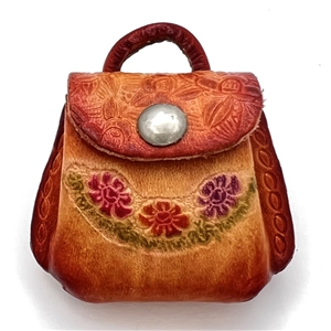 Leather button of a purse that opens.