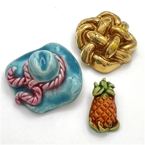 Three couture buttons by French ceramist Helene Mechin.