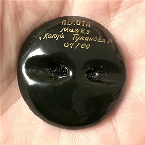 Russian lacquer button of a Lacota (Native American) mask. 