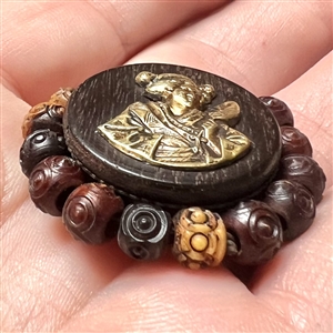 Div I - brass Asian woman on wood button with bone bead border.