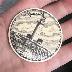 Scrimshaw on plastic of the lighthouse at Plymouth by L. Layden.
